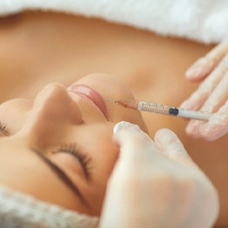 Close-up of woman receiving BOTOX® injection in lip