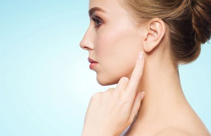 woman pointing to earlobe
