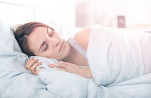 Woman sleeping peacefully after sleep apnea surgery in Chicago