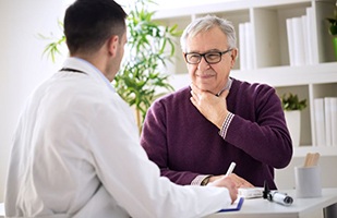 Patient and doctor discussing throat surgery