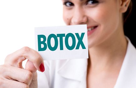 Woman holding a card reading “Botox.”