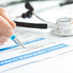 Using pen to fill out health insurance claim form