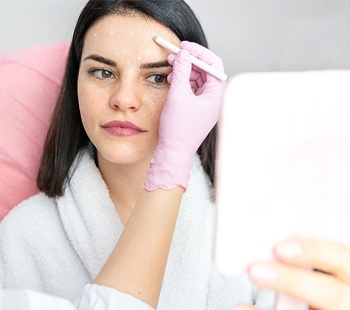 Woman being prepared to receive multiple filler injections