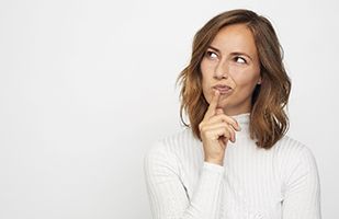 Woman wondering if “bargain” earlobe rejuvenation is right for her