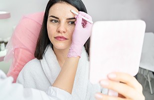 Woman being prepared to receive multiple filler injections