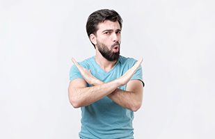Man saying no to “cheap” cosmetic facial fillers
