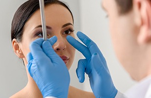 Doctor examining patient’s nose