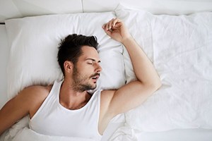 Snoring man who may need sleep apnea treatment
