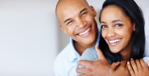 Smiling woman being embraced by her boyfriend