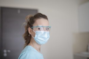 Woman at facial plastic surgeon during COVID.