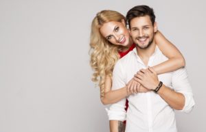 Attractive couple smiling after visiting facial plastic surgeon