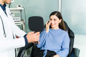 Patient smiling after successful rhinoplasty