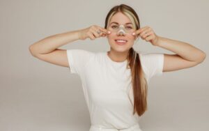 Woman wearing splint on her nose after rhinoplasty