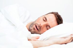 Snoring man sleeping with his mouth open