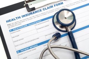 Health insurance claim form on clipboard