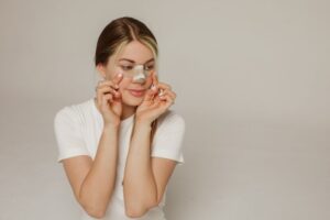Woman with bandage on her nose after rhinoplasty